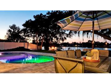 Inviting outdoor space with a pool and fire pit at sunset at 4708 26Th W Ave, Bradenton, FL 34209
