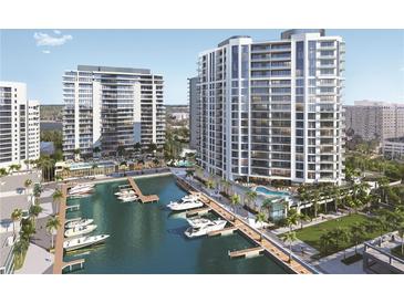 Stunning aerial view of waterfront condos and a yacht-filled marina, showcasing luxury living at 555 Quay Cmn # 1003, Sarasota, FL 34236