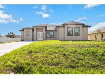 Stunning single-story home with a spacious driveway and meticulously maintained front yard at 6146 Grandeur St, Englewood, FL 34224