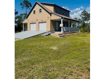 Inviting two-story home with a spacious two-car garage and charming front porch at 8412 Grove Blvd, Punta Gorda, FL 33982