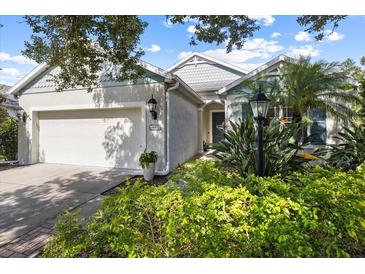 Charming single-Gathering home featuring lush landscaping and an attached two-car garage at 4402 Natures Reach Ter, Parrish, FL 34219