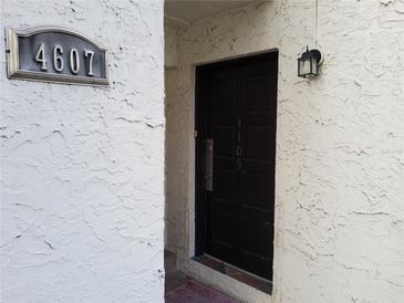 Inviting front entrance with a dark-colored door and house number displayed at 4607 W North B St # 105, Tampa, FL 33609