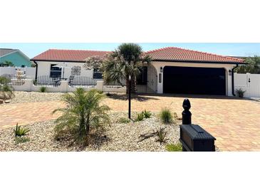 Charming single story home featuring a red tile roof, front yard landscaping and a brick paver driveway at 6524 Senegal Palm Way, Apollo Beach, FL 33572