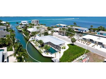 Waterfront home with private pool and dock offering direct access to the Gulf of Mexico at 791 Saint Judes Dr N, Longboat Key, FL 34228