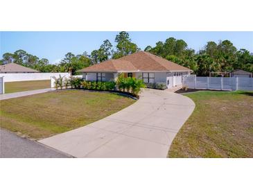 Charming single-story home with a long driveway and well-manicured landscaping at 12214 Hernando Rd, North Port, FL 34287