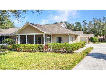Well-maintained home with a screened-in porch and lush landscaping showcasing curb appeal at 1651 Red Oak Ln, Port Charlotte, FL 33948