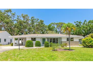 Charming single-story home with well-maintained lawn and mature trees at 2110 Craft Ln, Sarasota, FL 34239
