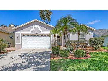 Charming single-story home with lush landscaping, a manicured lawn, and a two-car garage at 4208 Balmoral Way, Sarasota, FL 34238