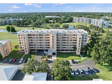 Expansive aerial view of the condo building, showcasing its landscaping, parking, and proximity to golf course at 4410 Fairways Blvd # 104, Bradenton, FL 34209
