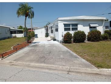 Cozy single-story home featuring a palm tree and driveway in a well-maintained community at 5118 Oakland Hills Ave, Sarasota, FL 34234