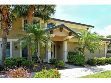Charming home showcasing a well-manicured lawn and tropical landscaping for curb appeal at 6552 Moorings Point Cir # 201, Lakewood Ranch, FL 34202