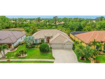 Charming single-story home with a well-manicured lawn and a three-car garage in a lush neighborhood at 7126 Southgate Ct, Sarasota, FL 34243