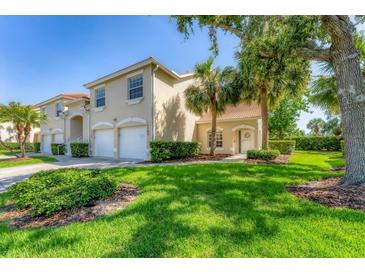 Charming home exterior with lush lawn, a two-car garage, and manicured landscaping at 7160 Cedar Hollow Cir, Bradenton, FL 34203