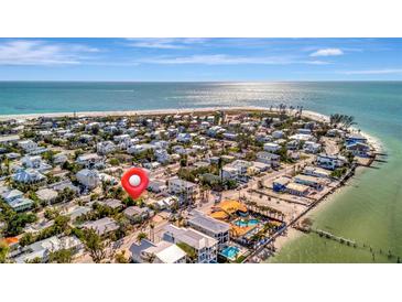 Stunning aerial view of a coastal community with beachfront homes and sparkling ocean views on a sunny day at 880 N Shore Dr, Anna Maria, FL 34216
