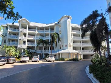 Beautiful condominium complex with well-maintained landscaping, covered parking, and easy access to amenities at 1280 Dolphin Bay Way # 204, Sarasota, FL 34242