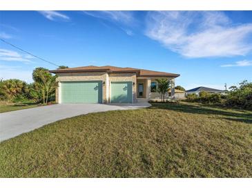 Charming single-story home featuring a manicured lawn, stone accents, and two-car garage doors at 144 Spring Dr, Rotonda West, FL 33947