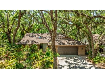 Charming single-story home with a two-car garage and lush landscaping at 2061 Misty Sunrise Trl, Sarasota, FL 34240