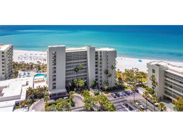Stunning beachside condominium with pool, palm trees, and white sandy beach access at 230 Sands Point Rd # 3404, Longboat Key, FL 34228