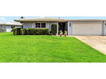 Well-maintained home featuring lush green lawn and manicured landscaping at 3649 Somerville Dr # 1507, Sarasota, FL 34232