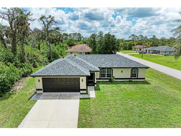 Charming single-story home with a well-manicured lawn, two-car garage, and inviting curb appeal at 5482 Globe Ter, North Port, FL 34286