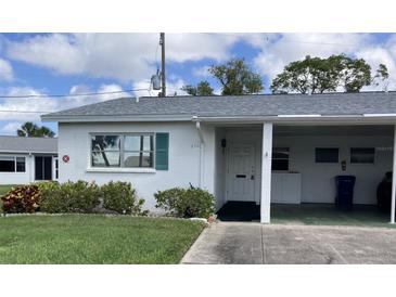 Charming home with green shutters, a covered carport, and well-maintained landscaping at 6110 Coral Way, Bradenton, FL 34207