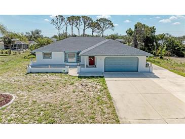 Charming single-story home featuring a well-maintained yard and an attached two-car garage at 645 Liberty St, Englewood, FL 34223