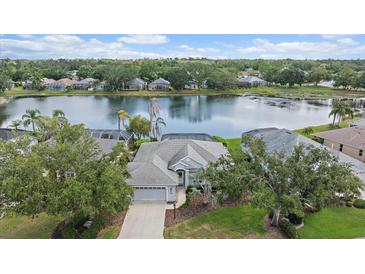 Beautiful single-Gathering home with mature trees, well-manicured lawn and lake front view at 6552 Meandering Way, Lakewood Ranch, FL 34202