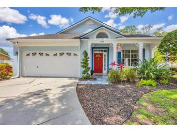Charming single-Gathering home with a well-maintained lawn, an attached two-car garage, and a vibrant red front door at 11208 Blue Sage Pl, Lakewood Ranch, FL 34202