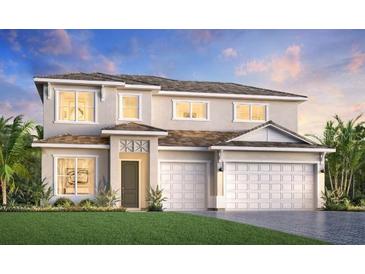 Elegant two-story home featuring a two-car garage, lush lawn, and inviting front entrance at 17723 Palmiste Dr, Bradenton, FL 34202
