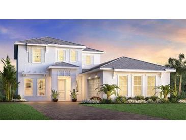 Charming two-story home with a well-maintained lawn, landscaped with shrubs and beautiful twilight skies at 17911 Palmiste Dr, Bradenton, FL 34202