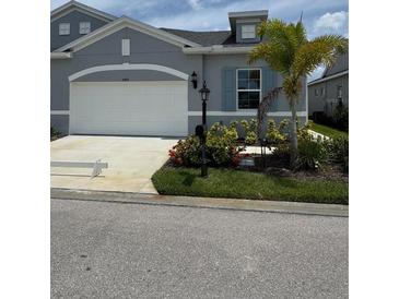 Charming single-Gathering home featuring a two-car garage and well-maintained landscaping at 24831 Buckingham Way, Port Charlotte, FL 33980