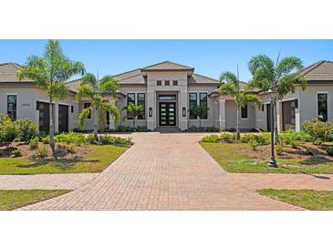 Beautiful single-story home featuring a tiled roof, symmetrical landscaping, and an inviting front entryway at 3212 Signet Ct, Sarasota, FL 34240