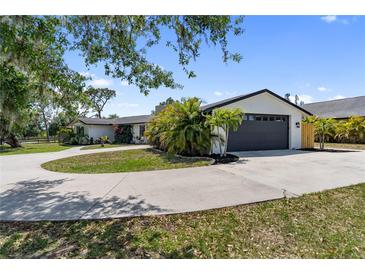 Charming single-story home featuring a circular driveway and an attached two-car garage at 3810 Hidden River Rd, Sarasota, FL 34240