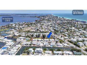Stunning aerial view of a waterfront community with canal access and Gulf of Mexico views at 407 63Rd St, Holmes Beach, FL 34217