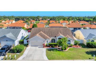 Charming single-story home with a well-maintained lawn, mature landscaping, and an attached two-car garage at 4585 Dover Street E Cir, Bradenton, FL 34203