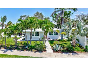 Charming home surrounded by tropical landscaping and well-manicured green spaces at 643 Calle Del Otono, Sarasota, FL 34242