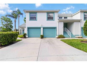 Inviting two-story condo with attached garage and a well-manicured lawn at 6572 Fairway Gardens Dr # 6572, Bradenton, FL 34203