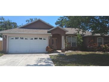 Charming single-story home featuring a two-car garage and a well-maintained front lawn at 7004 Mauna Loa Blvd, Sarasota, FL 34241