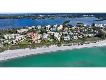 Stunning aerial view of beachfront condos with a pool and Gulf access at 8779 Midnight Pass Rd # 506H, Sarasota, FL 34242