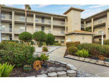 Well-maintained condominium complex featuring lush landscaping, sidewalks, and multiple stories with balconies at 9630 Club South Cir # 6303, Sarasota, FL 34238