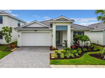 Charming single-story home featuring a well-manicured front yard and neutral paint at 18510 Midsummer Pl, Venice, FL 34293