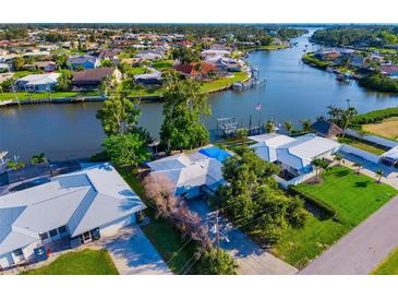 Waterfront homes feature boat docks along a tranquil canal, showcasing an idyllic coastal living community at 1921 Fairview Dr, Englewood, FL 34223