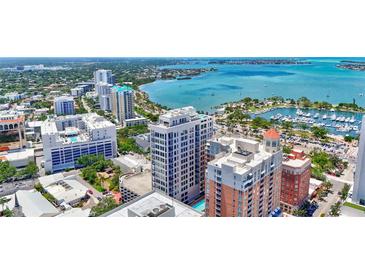Stunning aerial view of the modern high-rise condo with waterfront views and downtown cityscape at 33 S Palm Ave # 1101, Sarasota, FL 34236