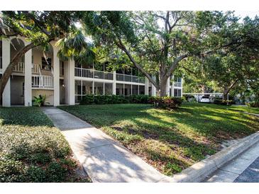 Condo building featuring lush landscaping and charming screened-in patios at 3745 Almeria Ave # 7S, Sarasota, FL 34239