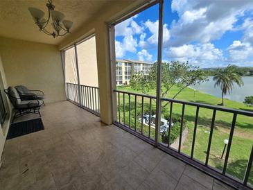 Enjoy the outdoors from this screened in balcony with a water view and seating area at 3917 Lake Bayshore Dr # F-307, Bradenton, FL 34205