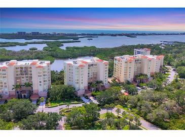 Stunning aerial view of three luxury condominiums with water views and lush landscaping at 401 N Point Rd # 504, Osprey, FL 34229