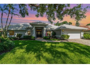 Beautiful home showcasing a manicured lawn and meticulously maintained landscaping at 4374 Indian Point Trl, Sarasota, FL 34238