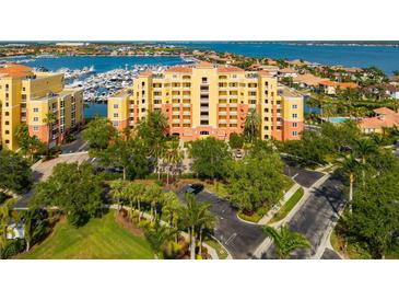 Beautiful waterfront building featuring lush landscaping and convenient parking at 610 Riviera Dunes Way # 503, Palmetto, FL 34221
