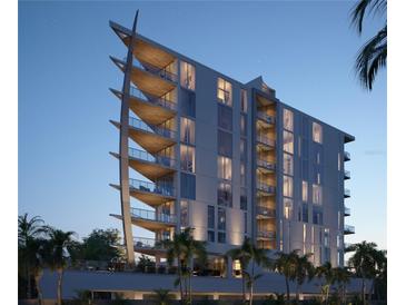Modern condo building with unique architecture, private balconies and lush tropical landscaping at 688 Golden Gate Point # 201, Sarasota, FL 34236