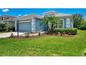 Charming home featuring a well-manicured lawn and lush landscaping, enhancing its curb appeal at 12229 Stuart Dr, Venice, FL 34293